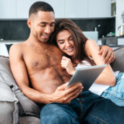 Man and woman reading on tablet together - MarriageHeat