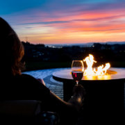 Enjoying a glass of wine at the outdoor fire table ~ MarriageHeat.