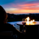 Enjoying a glass of wine at the outdoor fire table ~ MarriageHeat.