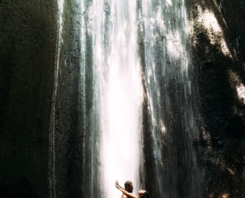 Man and wife sensually embracing in front of a waterfall ~ MarriageHeat