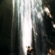 Man and wife sensually embracing in front of a waterfall ~ MarriageHeat