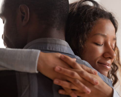Woman gives man a comforting hug - MarriageHeat