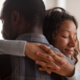 Woman gives man a comforting hug - MarriageHeat