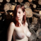 New mother leans topless against a woodpile ~ MarriageHeat