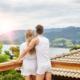 Husband and wife enjoy time alone on a hotel room balcony ~ MarriageHeat