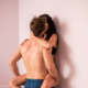 Husband kissing wife against the bathroom wall ~ MarriageHeat