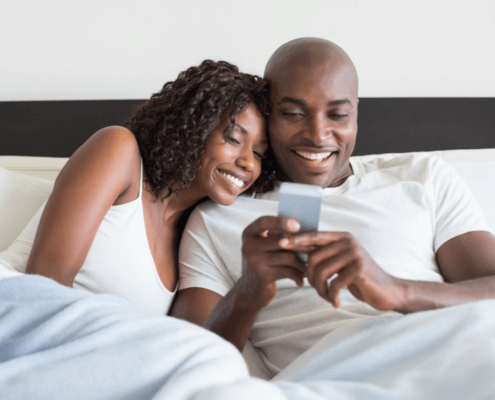 Husband and wife texting in bed ~ MarriageHeat