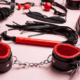 Collection of black-and-red BDSM implements ~ MarriageHeat