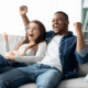 Husband and wife enjoying televised game together ~ MarriageHeat