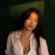 Young wife wearing her husband's shirt gazes absently out the window ~ MarriageHeat