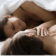 Young wife in bed looks adoringly at her husband ~ Marriageheat