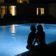 Husband and wife enjoying the pool after dark ~ MarriageHeat