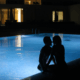 Husband and wife enjoying the pool after dark ~ MarriageHeat