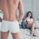 Husband stands before admiring wife in tight white boxers ~ MarriageHeat