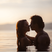Husband and wife kissing in a placid lagoon ~ MarriageHeat