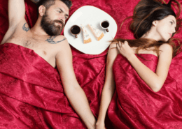 A husband and wife share cake and hold hands under silky red sheets~ MarriageHeat