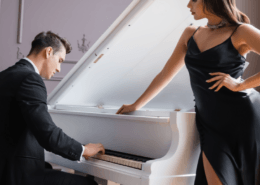 Husband plays the piano while his sexy wife looks on ~ MarriageHeat