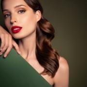 Young lady peeking out from behind a green board ~ MarriageHeat